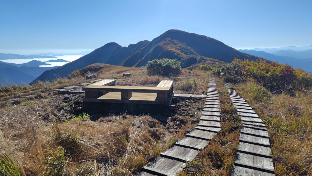 ベンチのある青雲岳の山頂部と守門岳